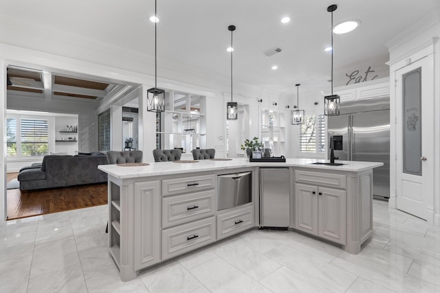 kitchen with built in fridge, pendant lighting, a center island, and beamed ceiling