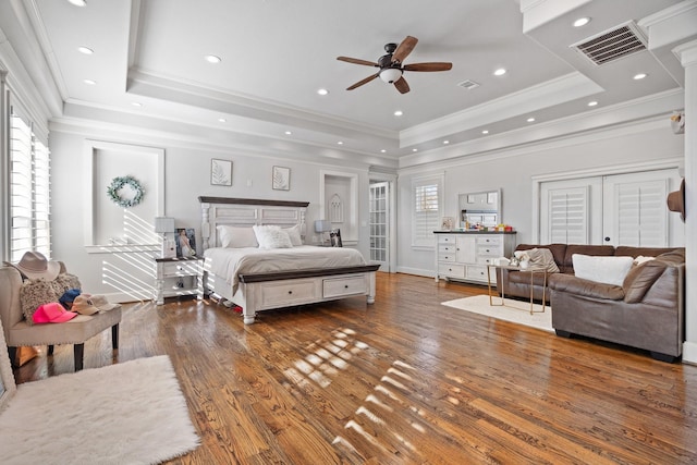 bedroom featuring ceiling fan, french doors, dark hardwood / wood-style flooring, and a raised ceiling