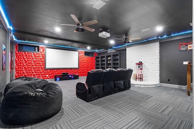 home theater room featuring carpet floors and built in shelves