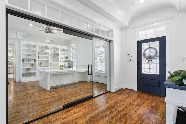 foyer with ceiling fan, dark hardwood / wood-style flooring, and vaulted ceiling