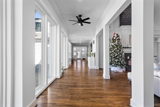 hall with ornate columns, ornamental molding, and dark hardwood / wood-style floors