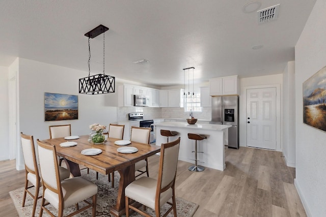 dining room with light hardwood / wood-style flooring