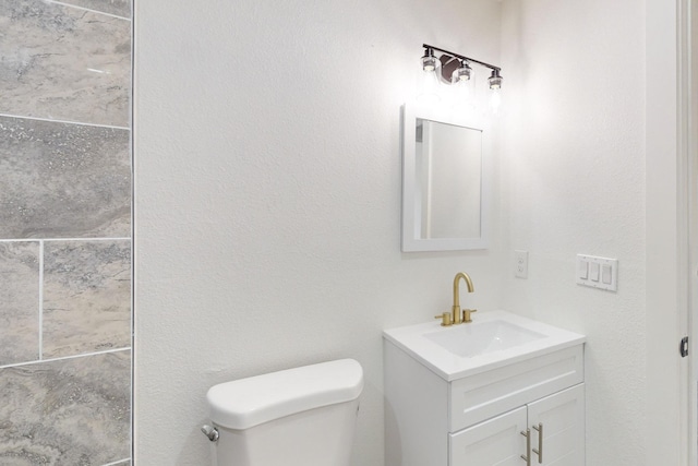 bathroom with toilet and vanity