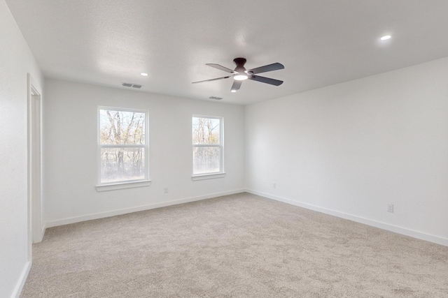 carpeted empty room featuring ceiling fan