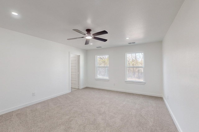 carpeted empty room featuring ceiling fan