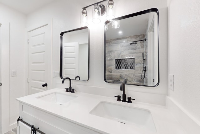 bathroom featuring a shower and vanity