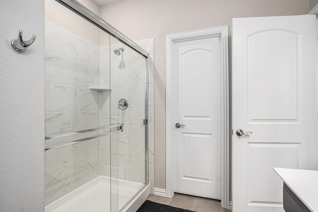 bathroom with vanity, tile patterned floors, and walk in shower