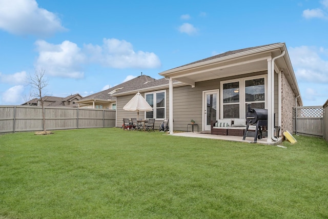 rear view of property with a patio and a yard