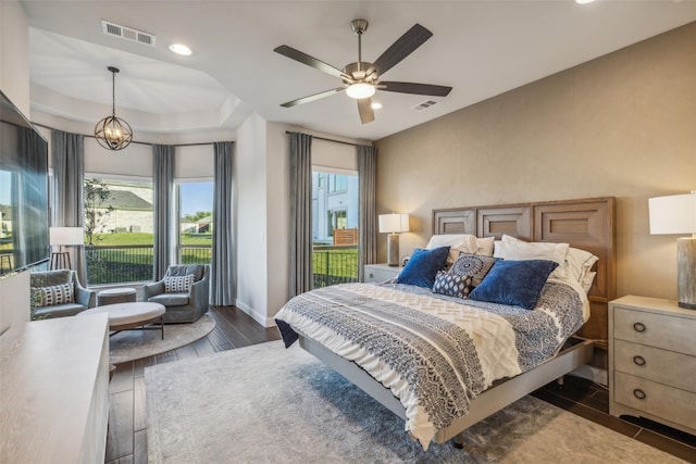 bedroom with ceiling fan with notable chandelier