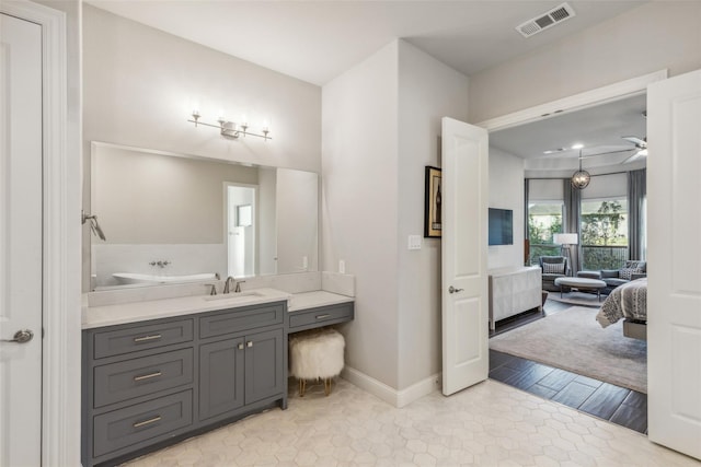 bathroom with ceiling fan, wood-type flooring, and vanity