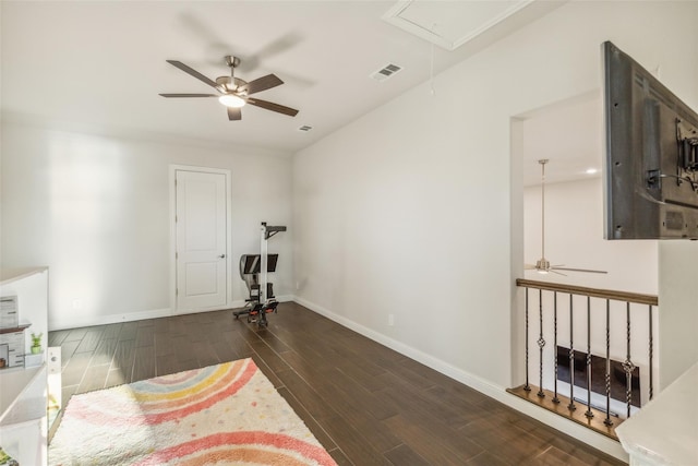 interior space with ceiling fan and dark wood-type flooring