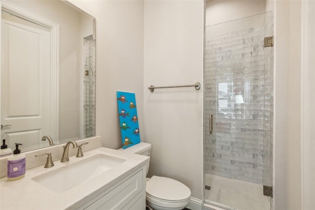 bathroom featuring toilet, walk in shower, and vanity