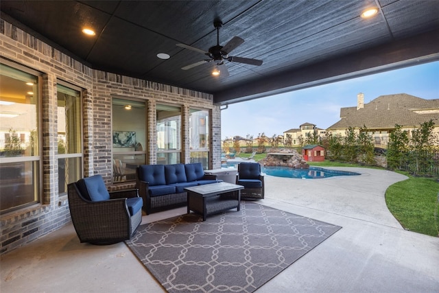 patio terrace at dusk with an outdoor hangout area, ceiling fan, and a fenced in pool