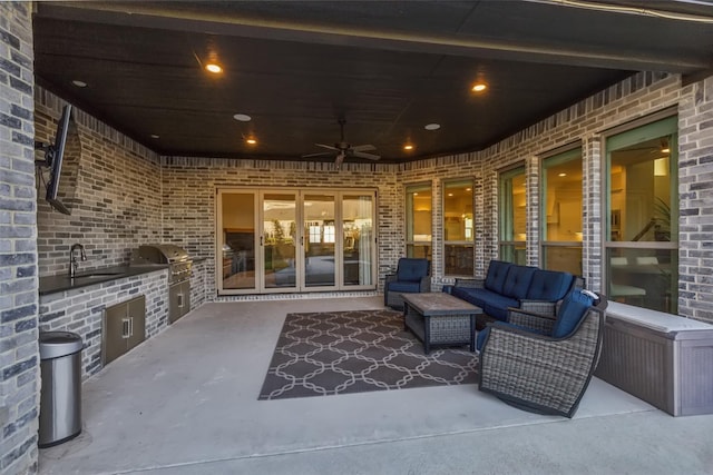 view of patio with ceiling fan, sink, and area for grilling