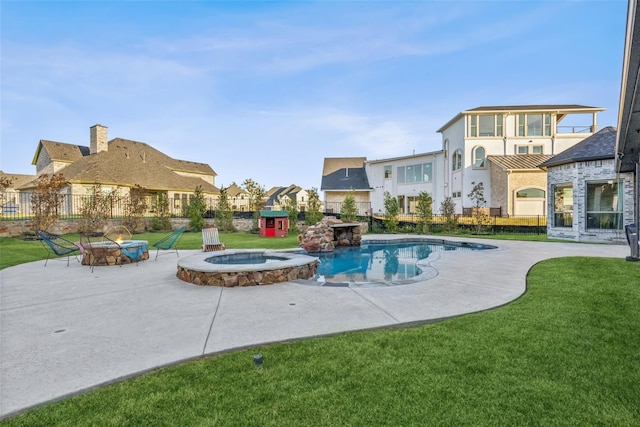 view of pool featuring a lawn, a patio area, and an in ground hot tub