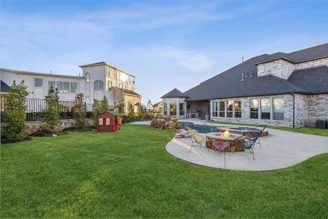 view of yard featuring an outdoor fire pit and a patio