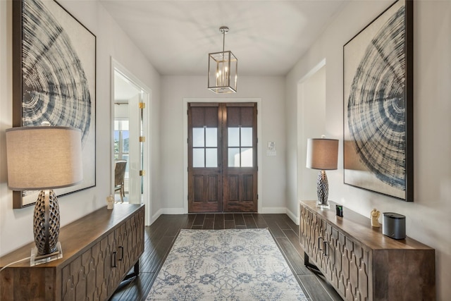 foyer entrance with french doors and an inviting chandelier