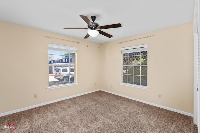 unfurnished room with ceiling fan and carpet