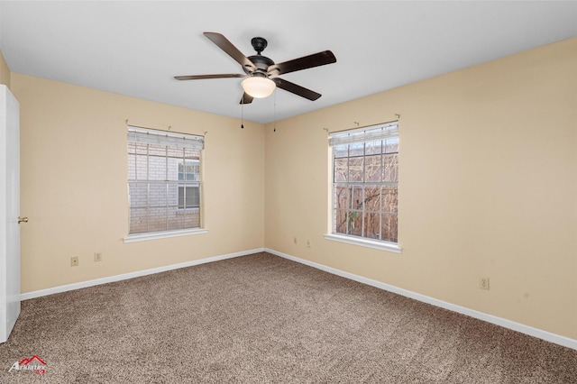 empty room with ceiling fan and carpet