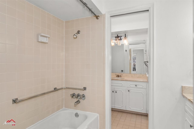 bathroom featuring vanity, tiled shower / bath combo, and tile patterned floors