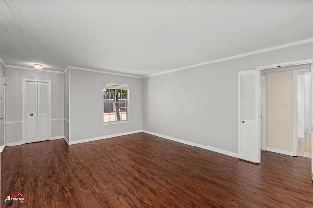 spare room with dark hardwood / wood-style floors and crown molding