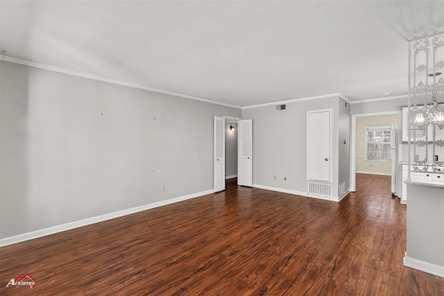 unfurnished living room with ornamental molding and dark hardwood / wood-style floors