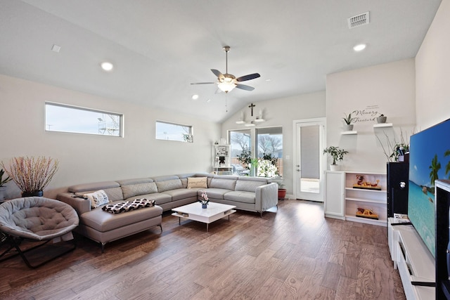 living room with ceiling fan, lofted ceiling, and wood-type flooring