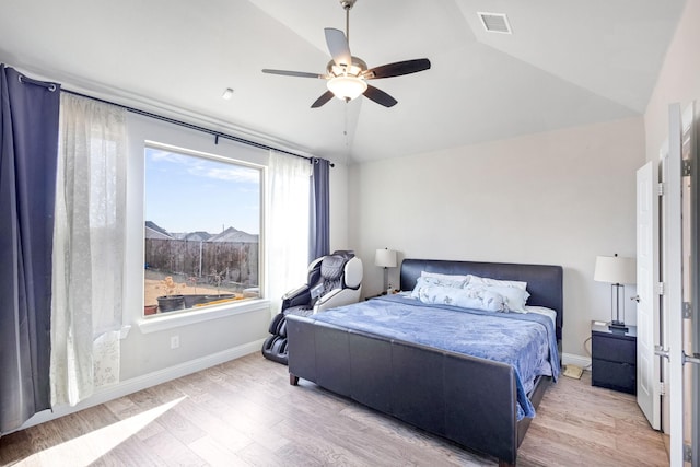 bedroom with ceiling fan, vaulted ceiling, and light hardwood / wood-style floors