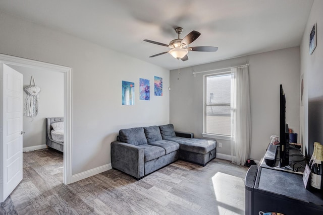 living room with ceiling fan and light wood-type flooring