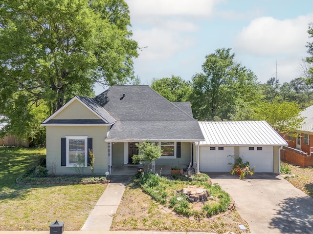 single story home featuring a front lawn and a garage