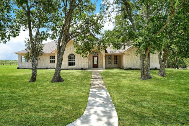 view of front of house featuring a front yard and brick siding