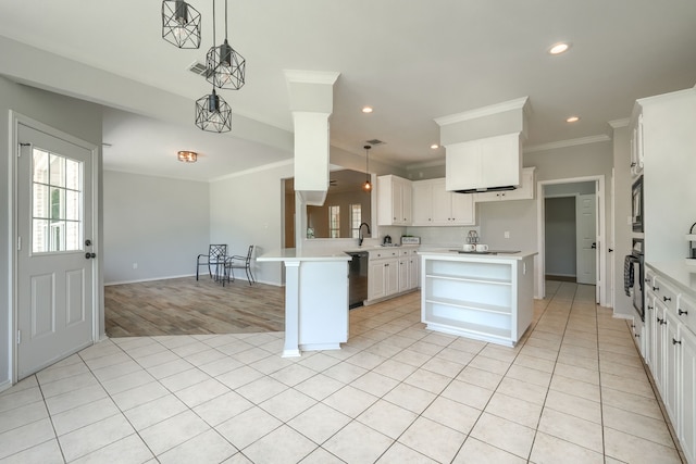 kitchen with hanging light fixtures, white cabinetry, a kitchen island, and black appliances