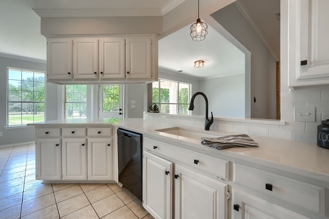 kitchen featuring decorative light fixtures, backsplash, white cabinets, and dishwasher