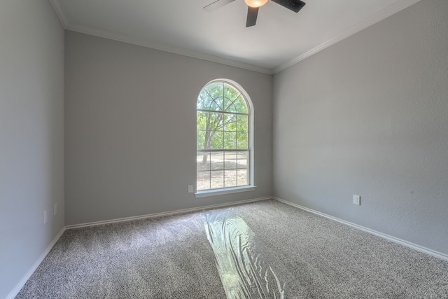 empty room featuring ornamental molding, ceiling fan, carpet floors, and baseboards