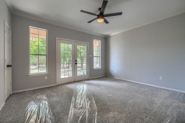 empty room with ceiling fan, carpet, crown molding, and french doors