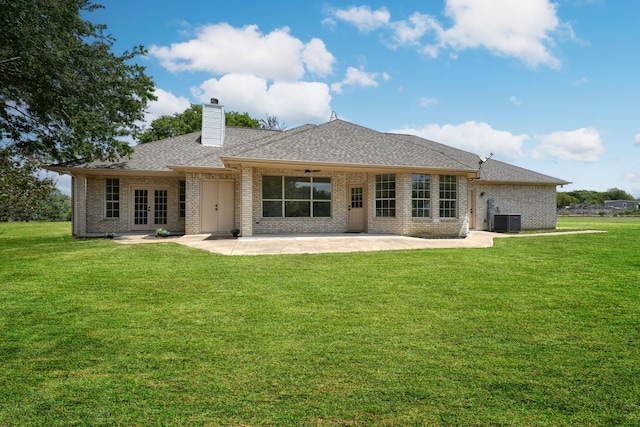 rear view of house featuring a patio area, cooling unit, and a yard