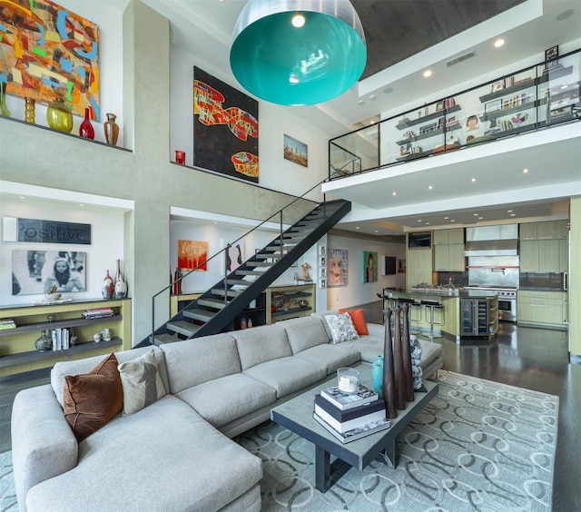 living room with wood-type flooring and a high ceiling