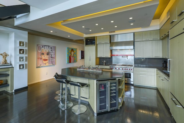 kitchen featuring wine cooler, backsplash, wall chimney range hood, a kitchen island, and double oven range