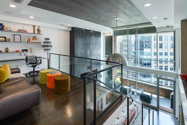 corridor with floor to ceiling windows and hardwood / wood-style flooring