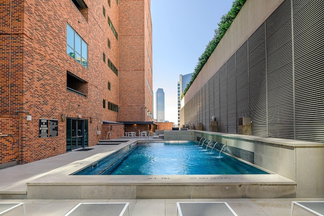 view of pool with pool water feature