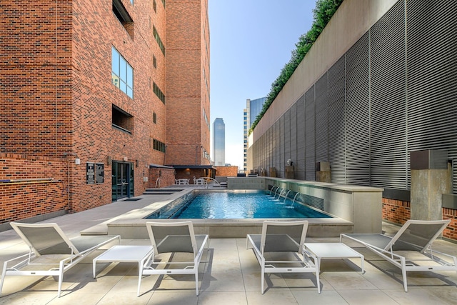 view of pool featuring pool water feature and a patio area