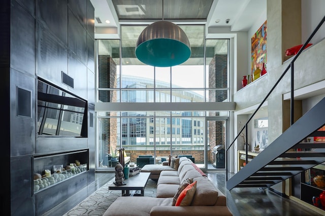 living room with a high ceiling and a large fireplace