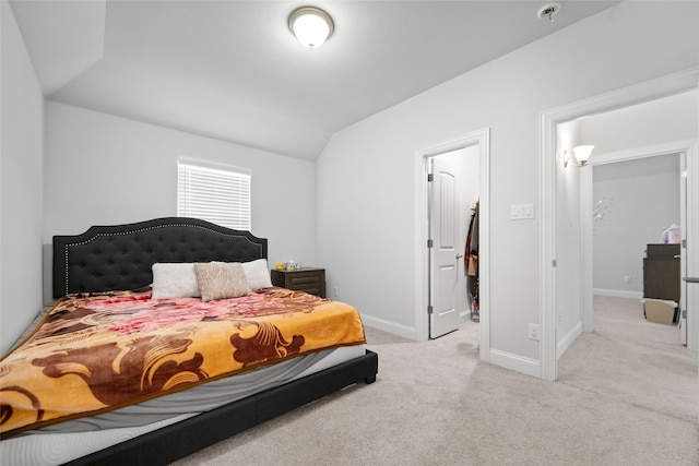 carpeted bedroom with vaulted ceiling