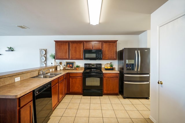 kitchen with light tile patterned floors, sink, kitchen peninsula, and black appliances