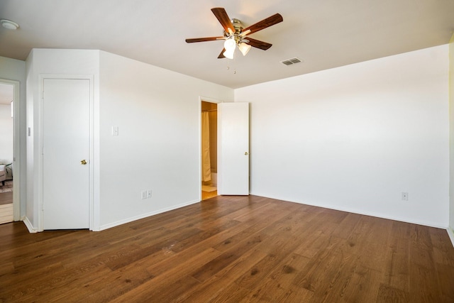 spare room with ceiling fan and dark hardwood / wood-style floors