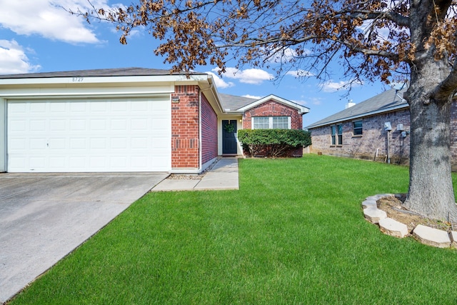 view of front of house with a garage and a front lawn