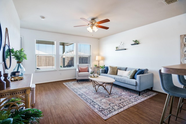 living room featuring ceiling fan and dark hardwood / wood-style flooring