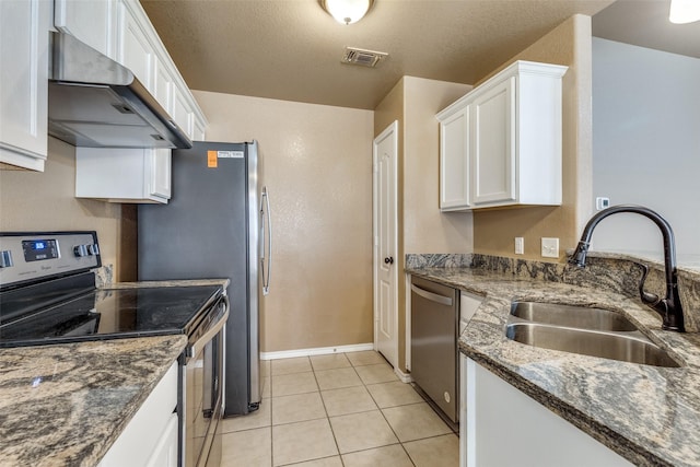 kitchen featuring dark stone countertops, sink, stainless steel appliances, white cabinets, and ventilation hood