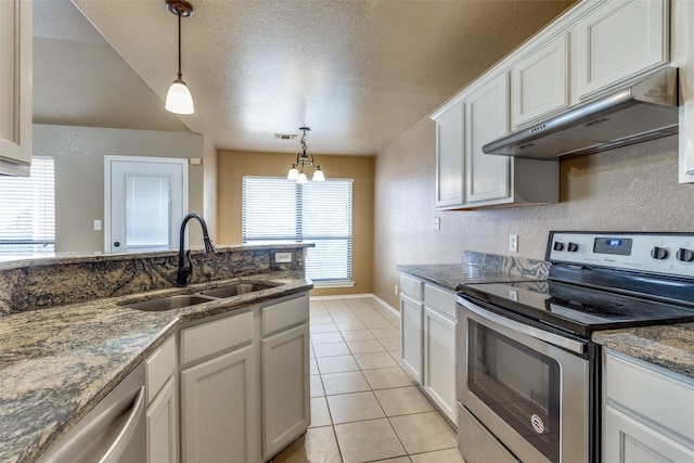 kitchen with sink, white cabinets, appliances with stainless steel finishes, and an inviting chandelier