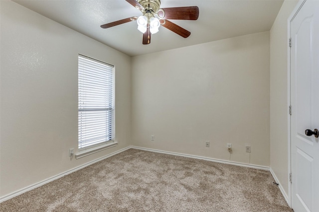 carpeted empty room featuring ceiling fan and a healthy amount of sunlight